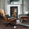 Luxurious modern living room featuring an elegant leather lounge chair with matching ottoman and contemporary fireplace, accented with stylish decor and cozy elements for a sophisticated home interior.